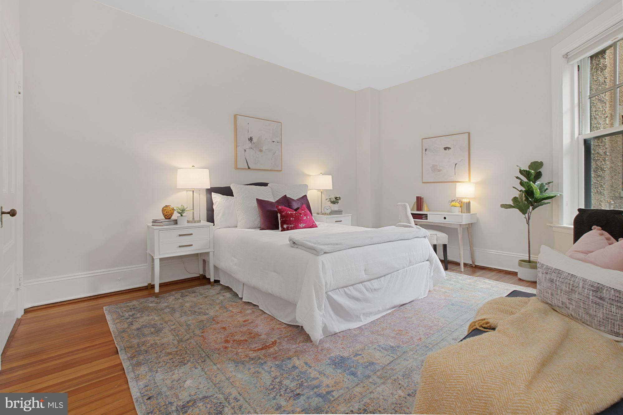 2853 Ontario Road Northwest, Unit 210 Washington, DC 20009 - Photo 18 of 28 a bed room with a bed and a chair