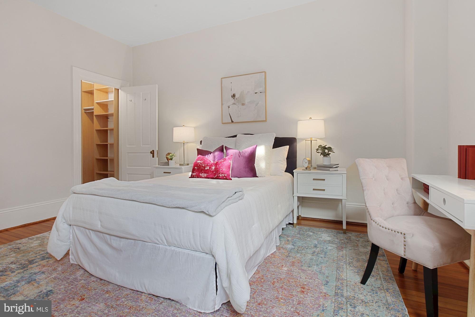 2853 Ontario Road Northwest, Unit 210 Washington, DC 20009 - Photo 20 of 28 a bedroom with a bed and a chair