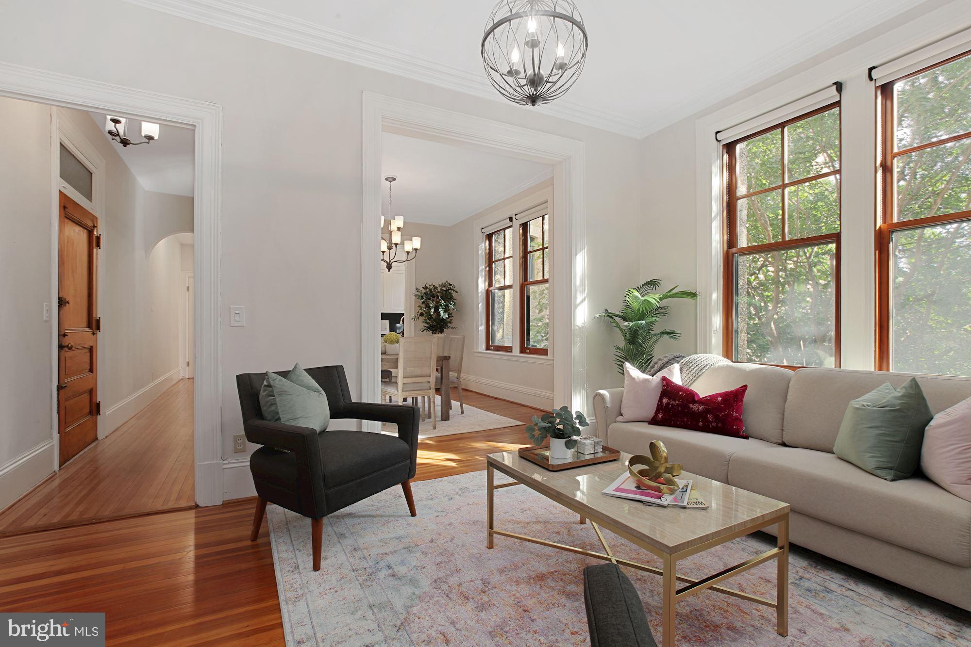 2853 Ontario Road Northwest, Unit 210 Washington, DC 20009 - Photo 6 of 28 a living room with furniture a rug and a large window