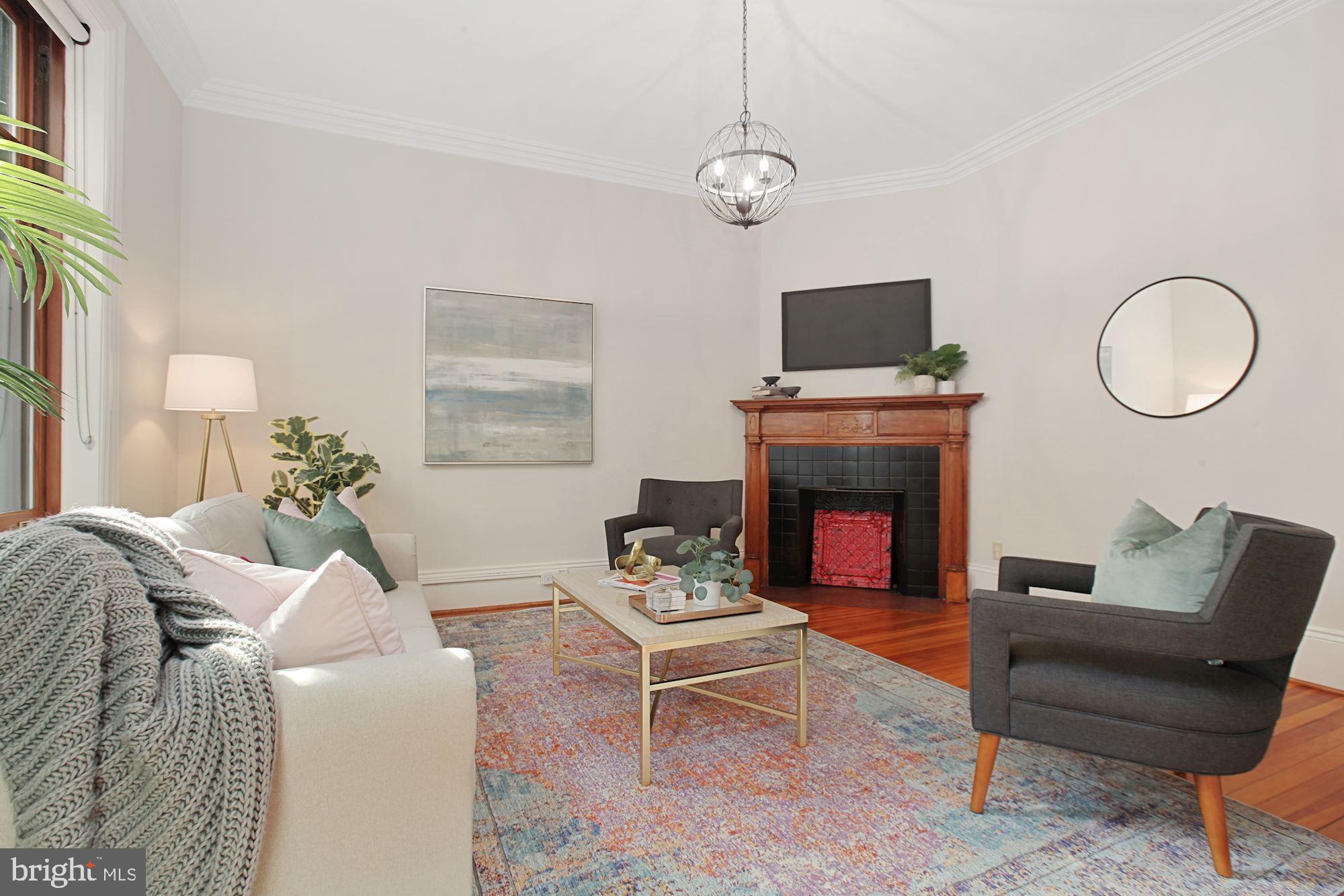 2853 Ontario Road Northwest, Unit 210 Washington, DC 20009 - Photo 7 of 28 a living room with furniture a fireplace and a flat screen tv