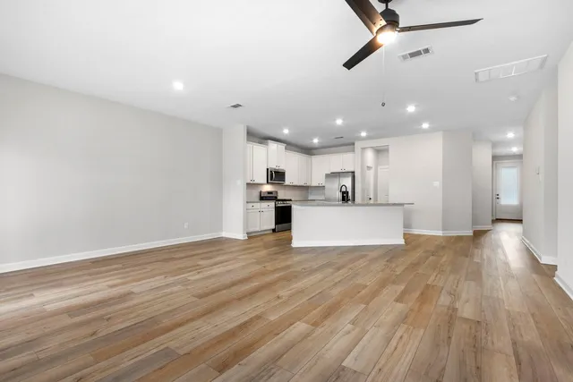 a view of a kitchen with a dishwasher cabinets and wooden floor
