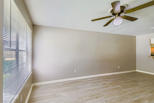 a view of room with a ceiling fan and window