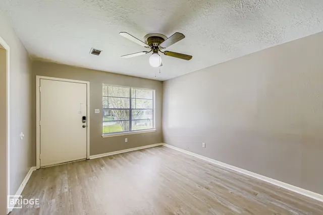 wooden floor in an empty room with a window