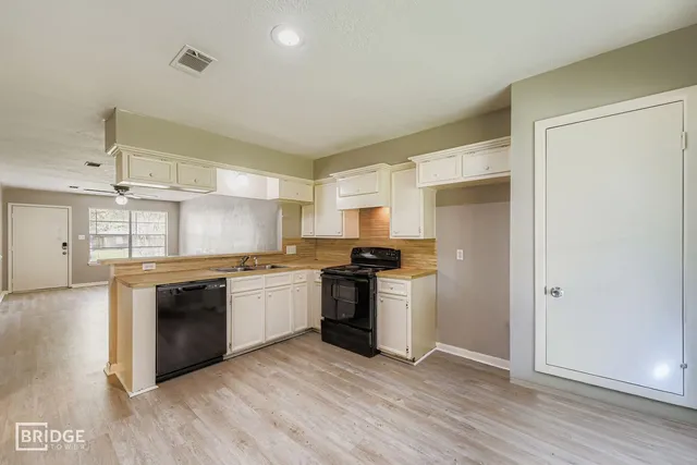 a kitchen with stainless steel appliances granite countertop a stove and a refrigerator