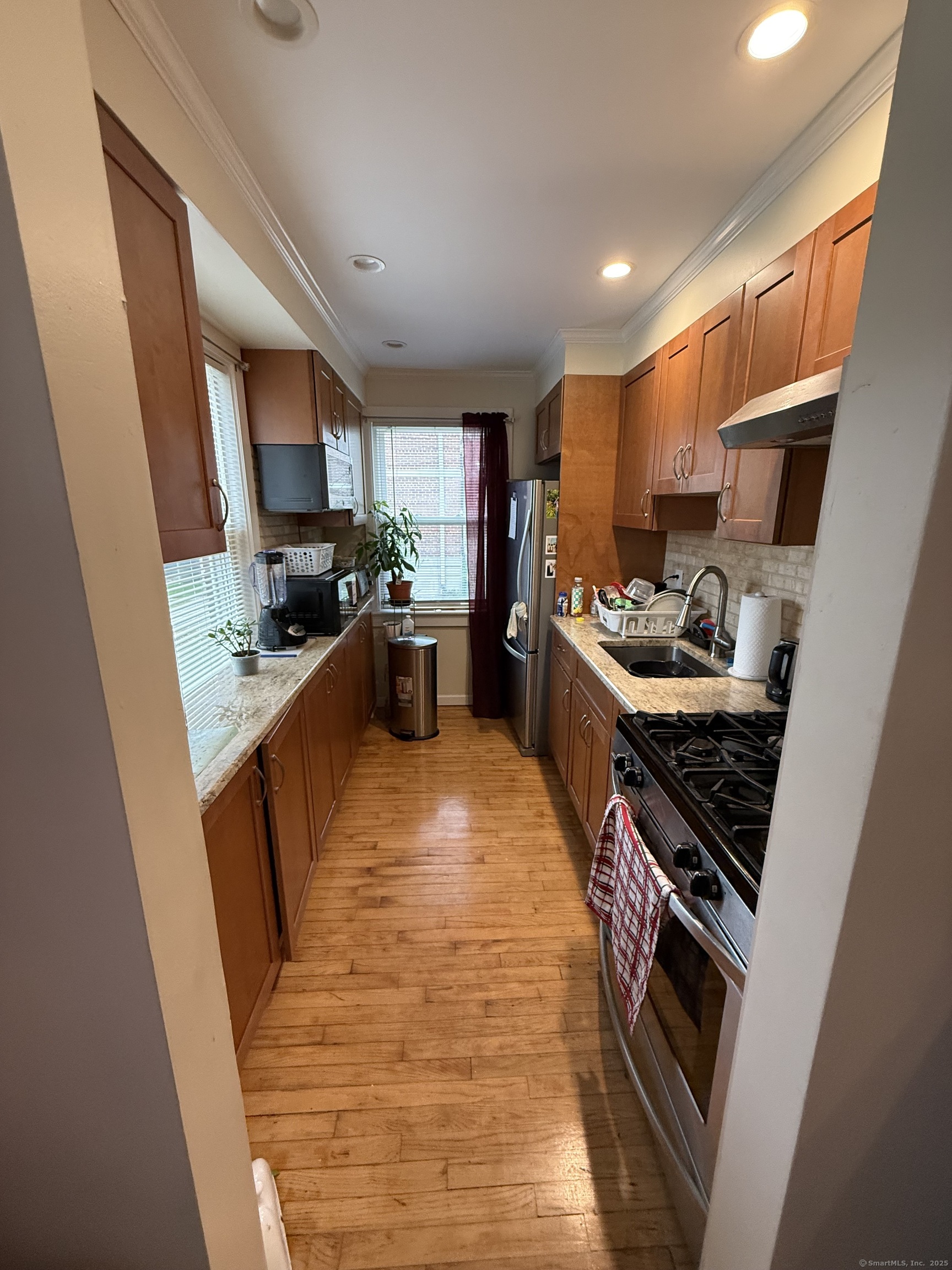 84 Canaan Court, Unit 11 Stratford, CT 06614 - Photo 4 of 13 a kitchen with a sink a stove a refrigerator and furniture