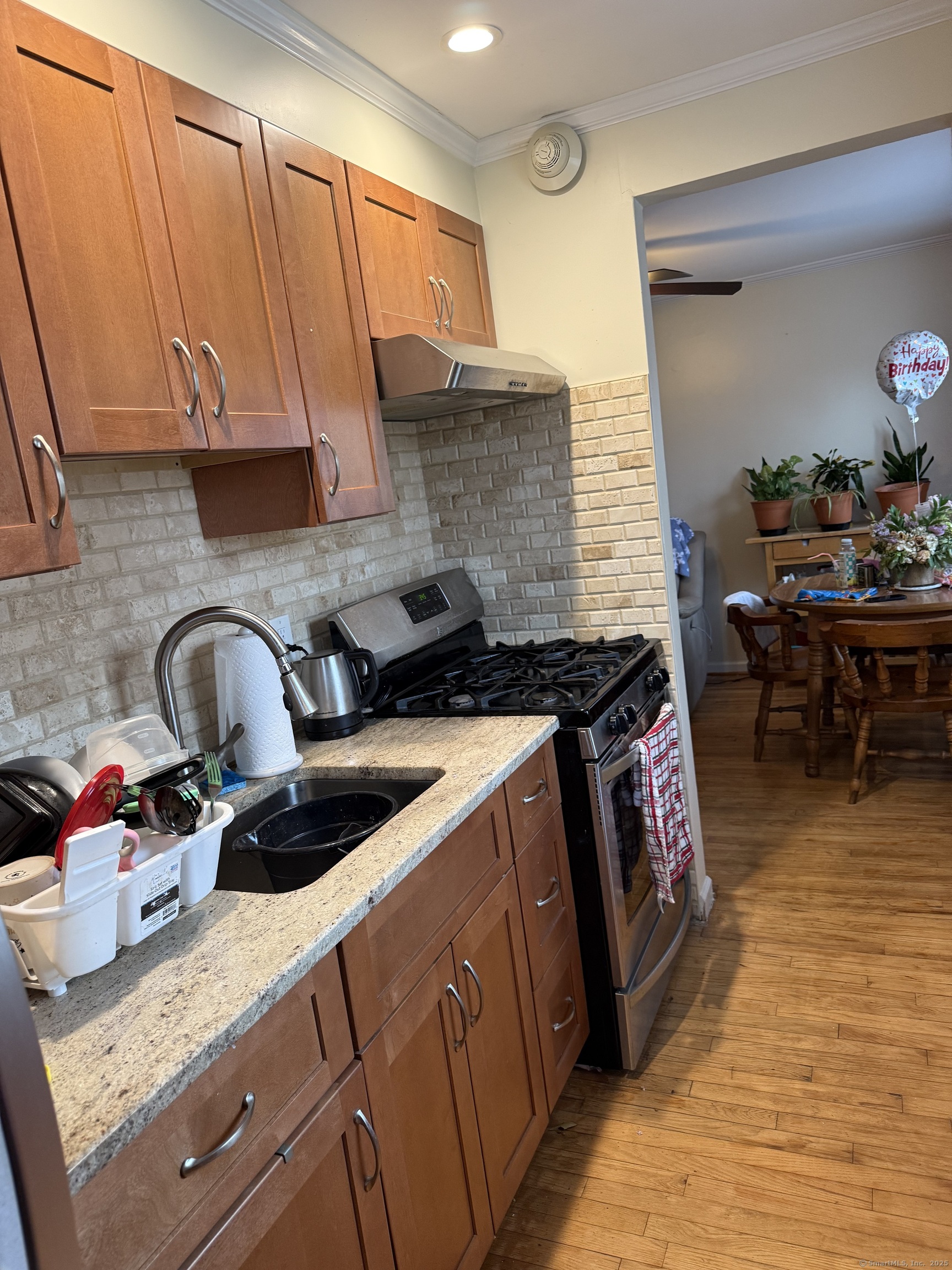 84 Canaan Court, Unit 11 Stratford, CT 06614 - Photo 5 of 13 a kitchen with granite countertop a sink a stove and cabinets