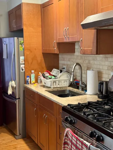 a kitchen with a stove and a wooden cabinets
