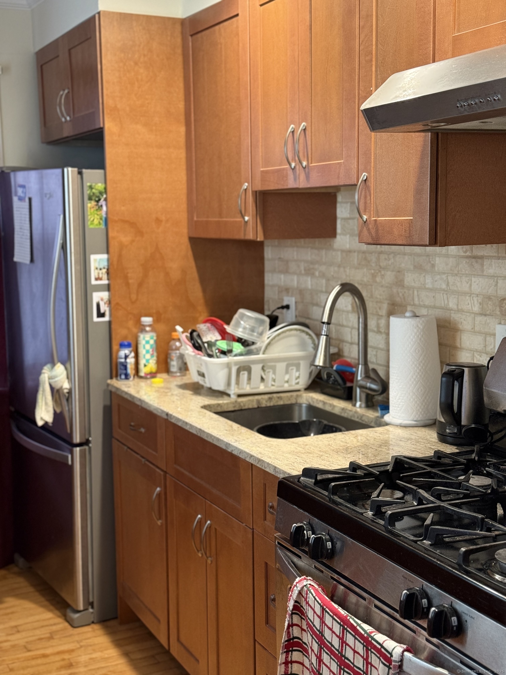 84 Canaan Court, Unit 11 Stratford, CT 06614 - Photo 6 of 13 a kitchen with a stove and a wooden cabinets