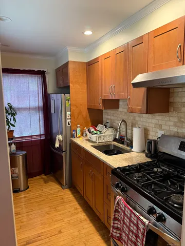 a kitchen with a stove a refrigerator and a sink