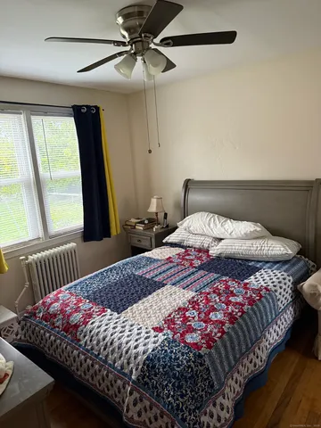 a bedroom with a bed and window