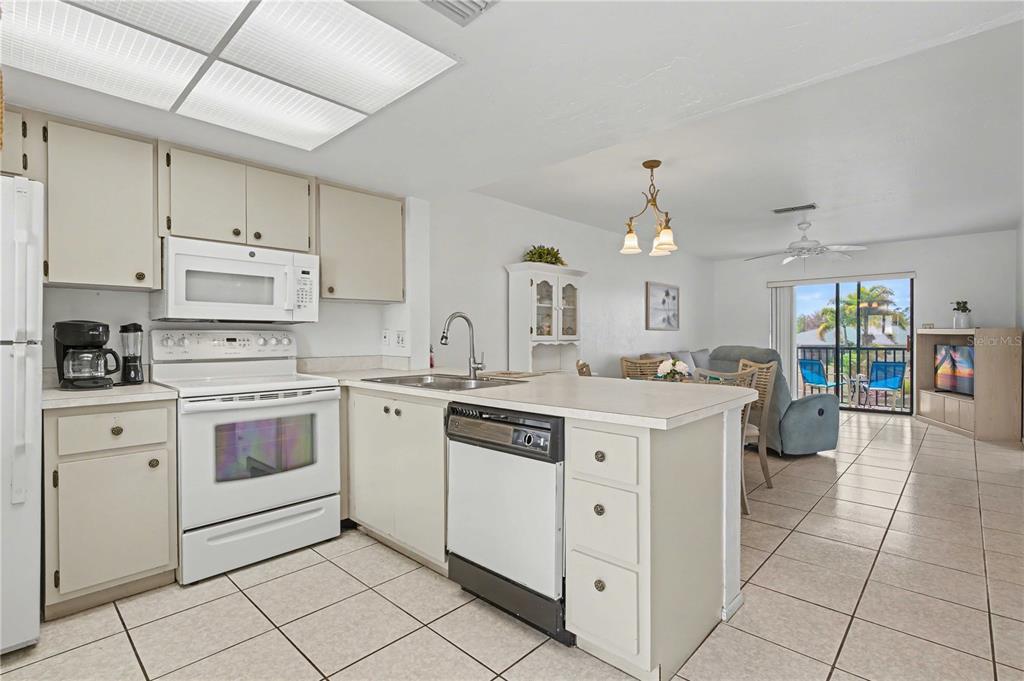 25225 Rampart Boulevard, Unit 1606 Punta Gorda, FL 33983 - Photo 17 of 34 a kitchen with white cabinets and white appliances