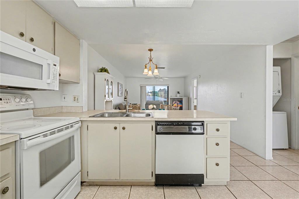 25225 Rampart Boulevard, Unit 1606 Punta Gorda, FL 33983 - Photo 19 of 34 a kitchen with white cabinets and white appliances