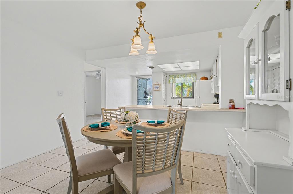 25225 Rampart Boulevard, Unit 1606 Punta Gorda, FL 33983 - Photo 20 of 34 a dining room with furniture a chandelier and window