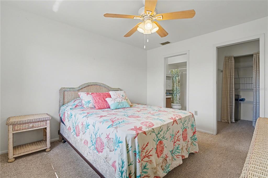 25225 Rampart Boulevard, Unit 1606 Punta Gorda, FL 33983 - Photo 24 of 34 a bedroom with a bed and a chandelier