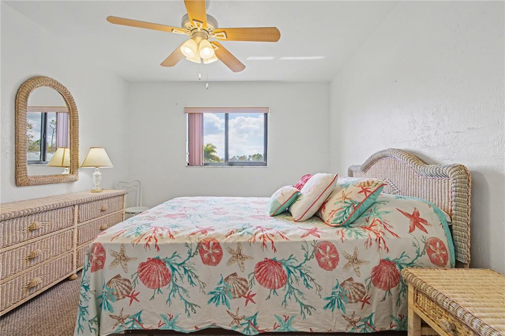 25225 Rampart Boulevard, Unit 1606 Punta Gorda, FL 33983 - Photo 25 of 34 a bedroom with a bed and a chandelier
