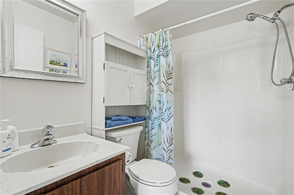 25225 Rampart Boulevard, Unit 1606 Punta Gorda, FL 33983 - Photo 27 of 34 a bathroom with a sink a toilet and shower curtain