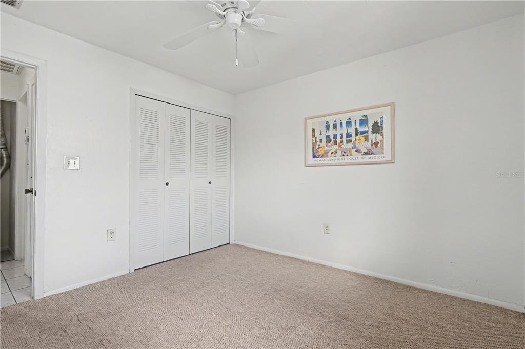 25225 Rampart Boulevard, Unit 1606 Punta Gorda, FL 33983 - Photo 29 of 34 an empty room with a chandelier fan