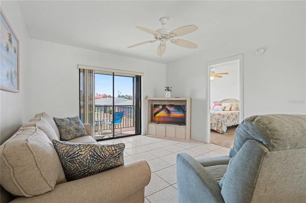 25225 Rampart Boulevard, Unit 1606 Punta Gorda, FL 33983 - Photo 5 of 34 a living room with furniture and a fireplace