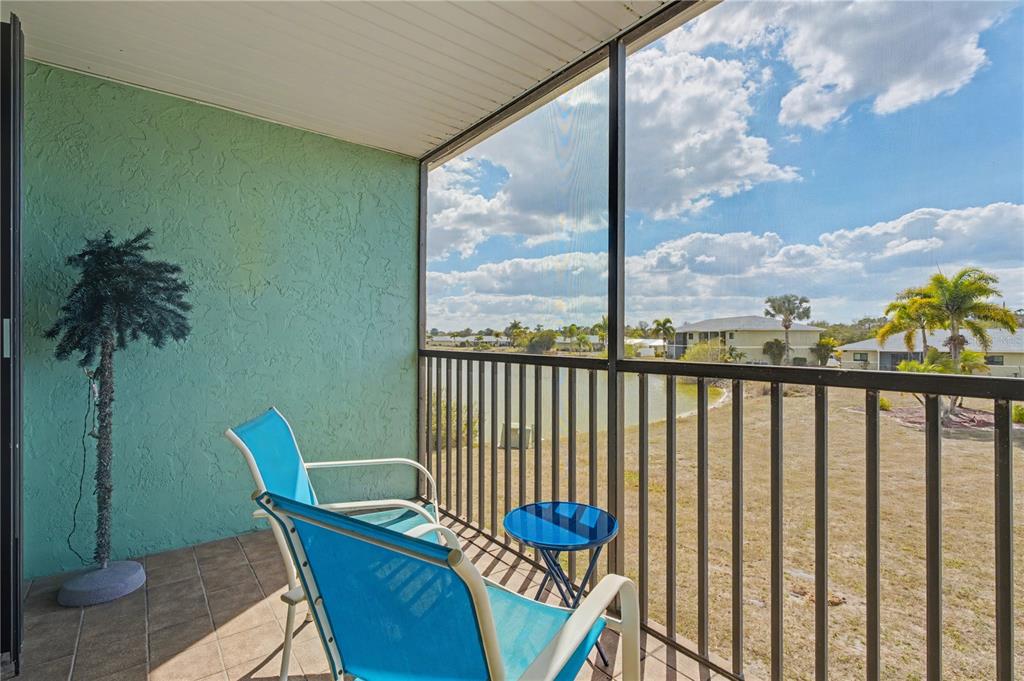 25225 Rampart Boulevard, Unit 1606 Punta Gorda, FL 33983 - Photo 6 of 34 a view of a chair and table in the balcony