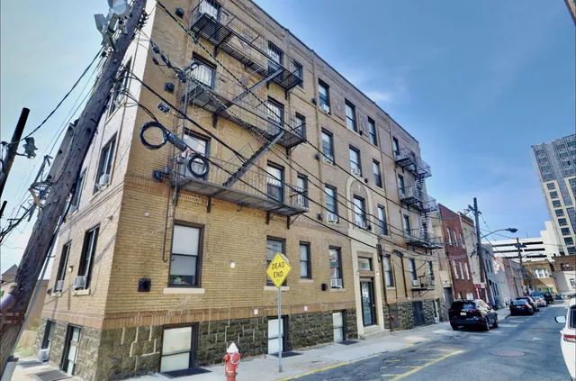 a view of a brick building next to a yard