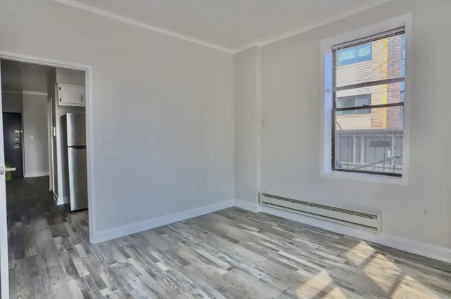 a view of a room with wooden floor and windows