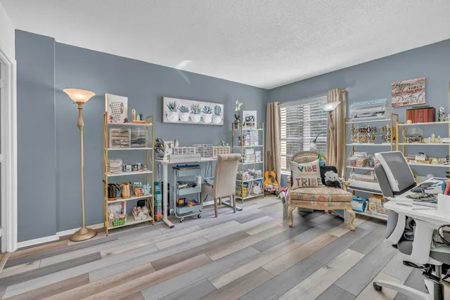 a view of a livingroom with workspace and a window