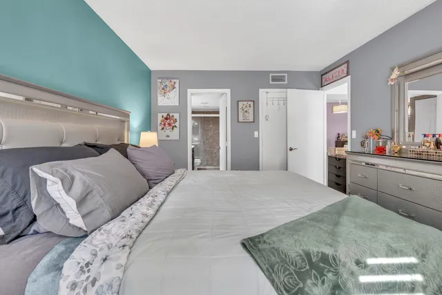 a bedroom with a large bed and a dresser