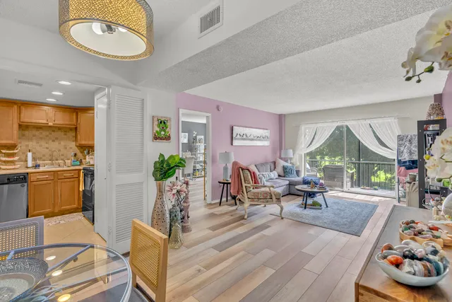 a living room with furniture and a floor to ceiling window