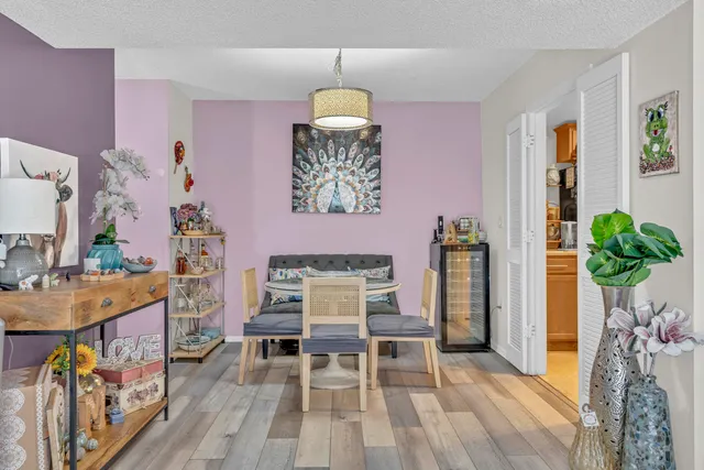 a dining room with furniture and wooden floor