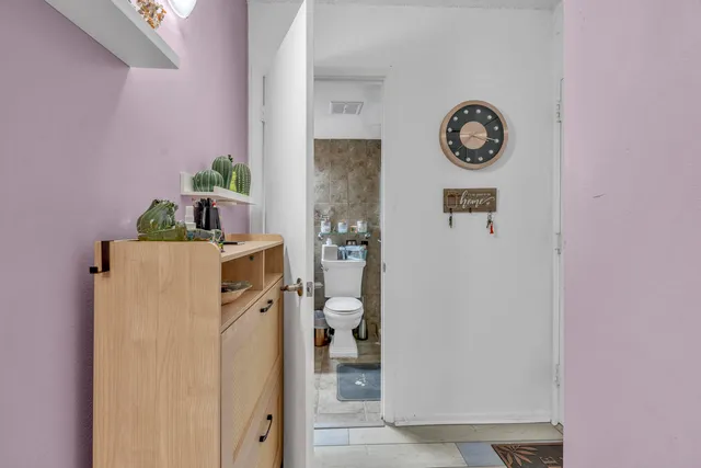 a utility room with a refrigerator and washer