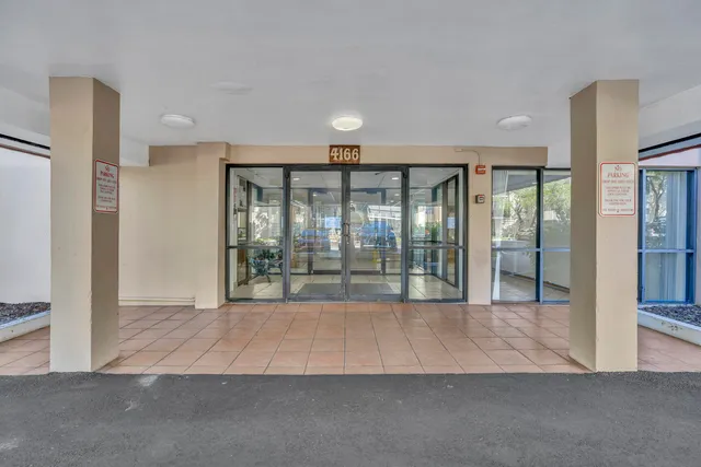 a view of an empty room with a fireplace and a floor to ceiling window