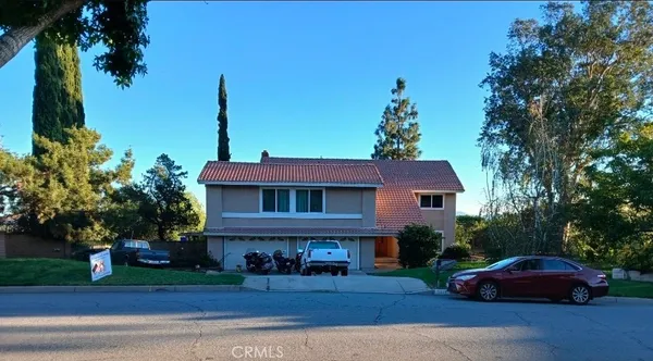 a front view of a house with trees