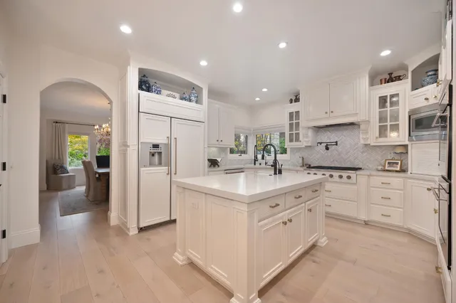 a living room with furniture a fireplace and a chandelier