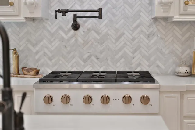a living room with furniture a fireplace and a chandelier