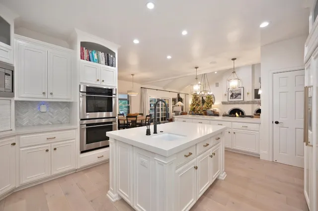 a spacious bedroom with a bed and a chandelier