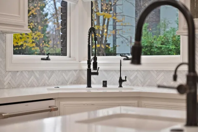 a bedroom with a bed a mirror on dresser and a flat screen tv