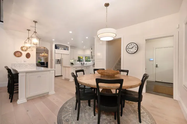 a living room with furniture lamps and a large window