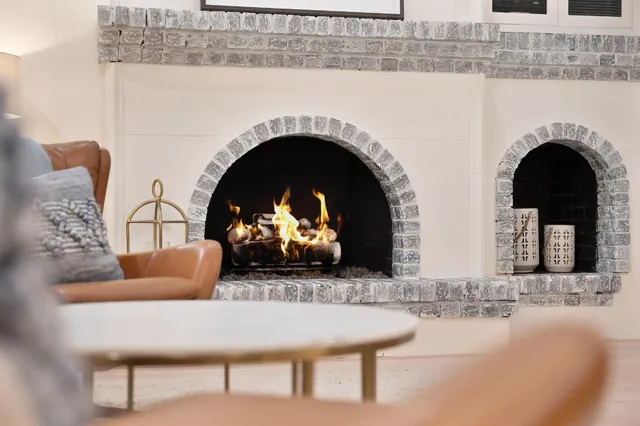a bathroom with a granite countertop sink a toilet and a mirror