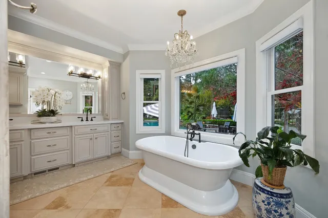a view of a patio with a table and chairs under an umbrella with a small yard