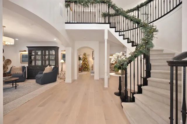 a living room with couch a fireplace and a large window