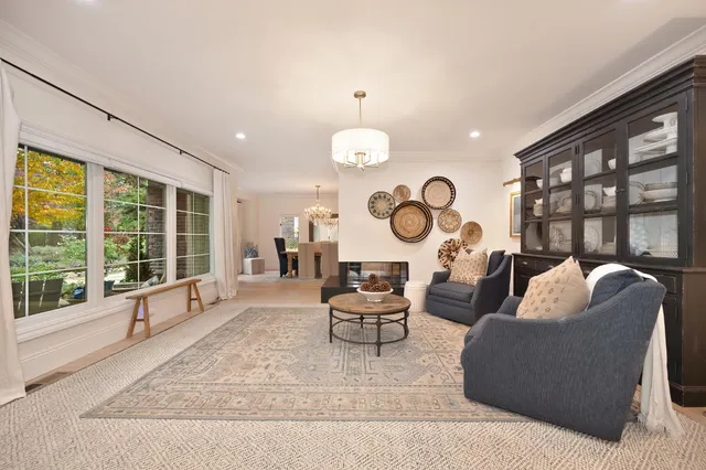 a dining room with wooden floor and a chandelier