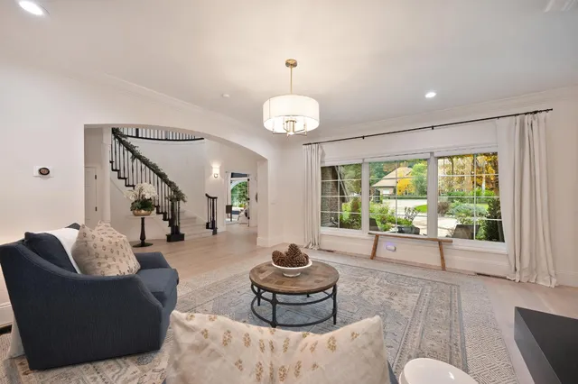 a view of a dining room with furniture a chandelier and window