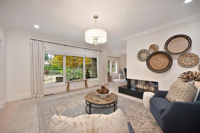 a view of a dining room with furniture and chandelier