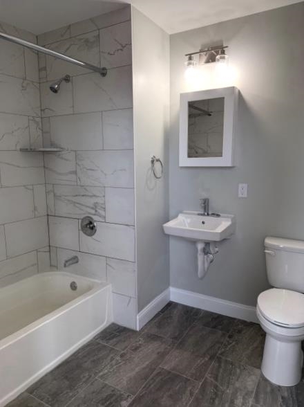 38 Mill Street, Unit 105 Paterson, NJ 07501 - Photo 5 of 6 a bathroom with a sink toilet and bathtub
