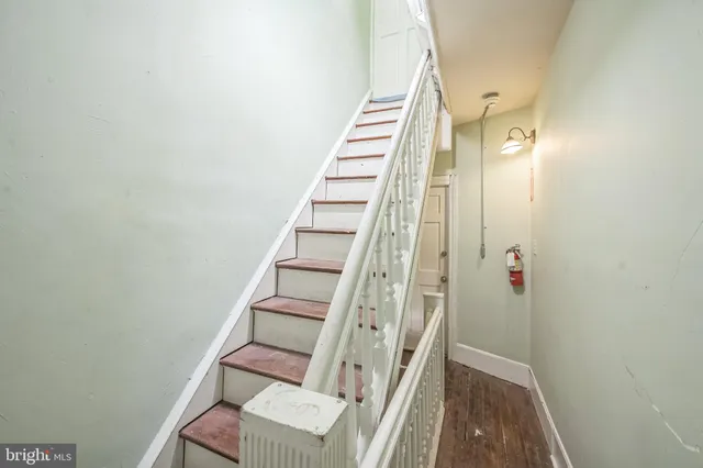 a view of a workspace with furniture and a book shelf