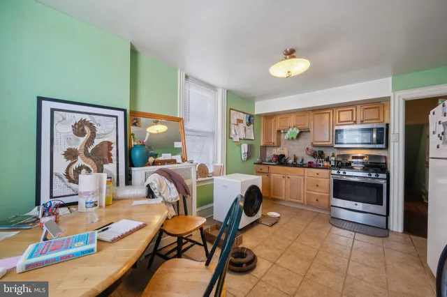 a kitchen with a stove top oven sink and cabinets