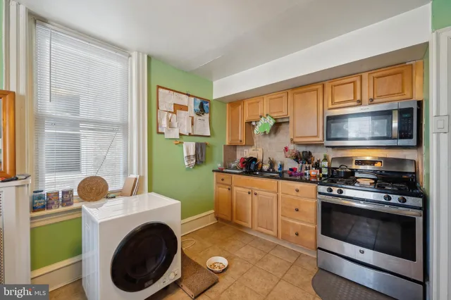a living room with furniture a window and a table