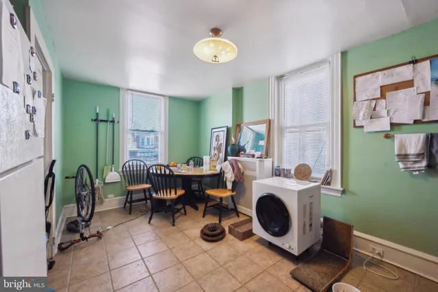 a spacious bedroom with a bed and wooden floor