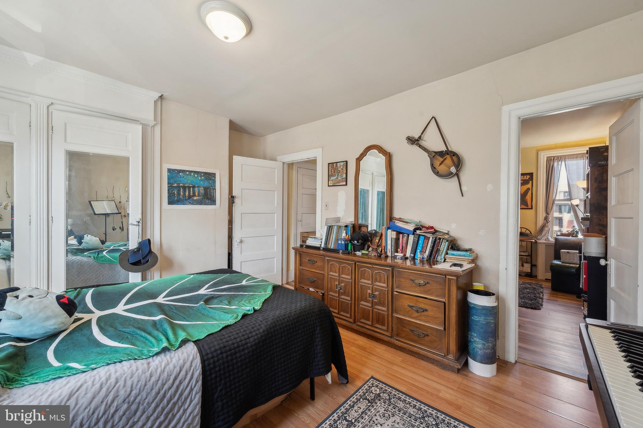 5131 Pine Street Philadelphia, PA 19143 - Photo 29 of 31 a bedroom with a bed and wooden floor