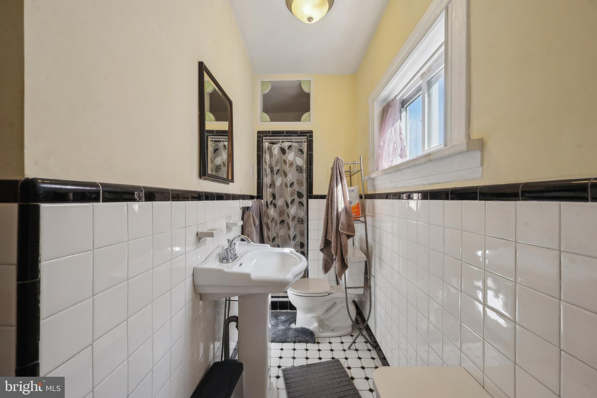 5131 Pine Street Philadelphia, PA 19143 - Photo 31 of 31 a bathroom with a sink and a mirror